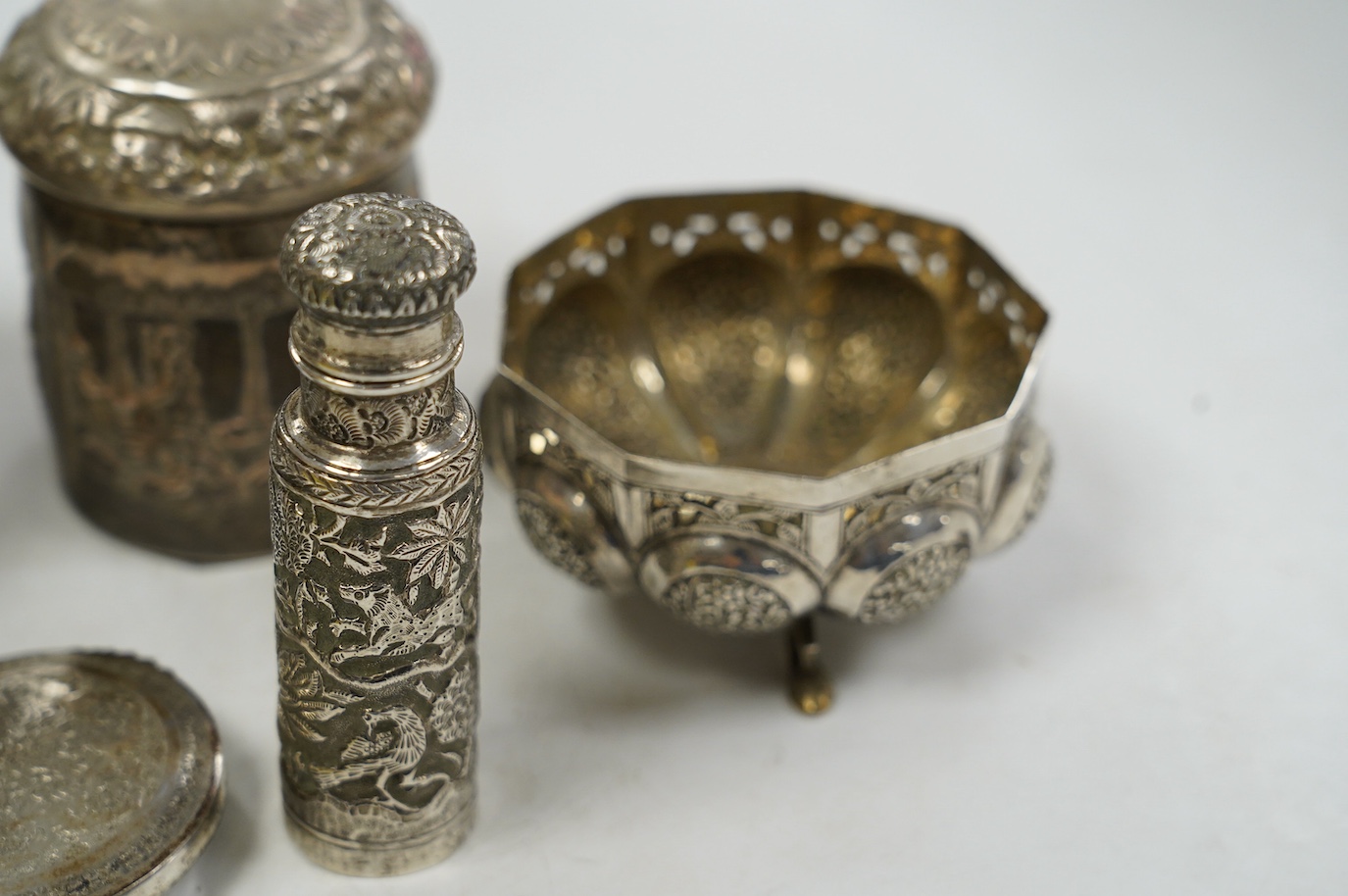 A pair of Indian pierced cusped white metal bowls, diameter 84mm, three other Indian white metal canisters and a Middle Eastern pill box. Condition - fair